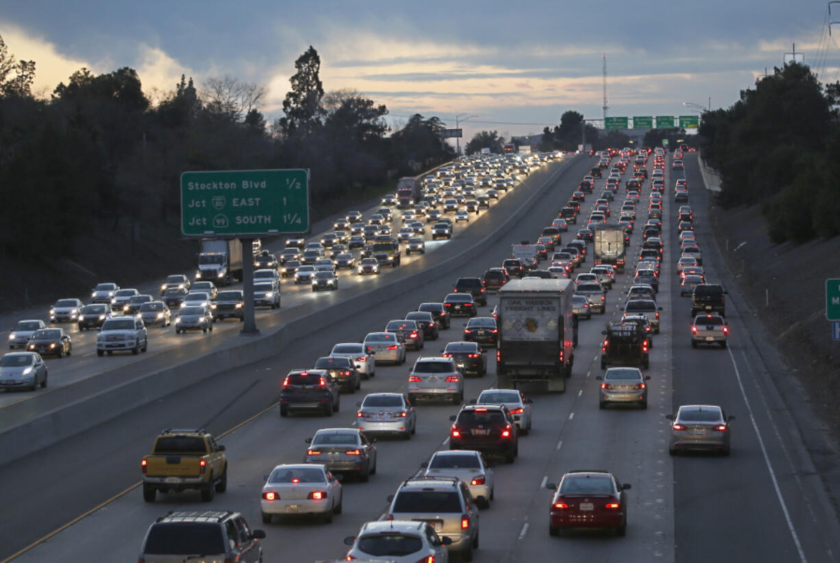 FILE - Evening rush hour traffic fills Highway 50, Jan. 26, 2017, in Sacramento, Calif.