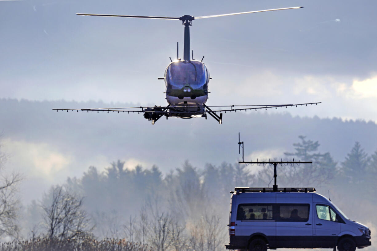 A Rotor Technologies unmanned semi-autonomous helicopter flies away from a van containing a ground control pilot/operator during a test flight over Intervale Airport, Monday, Nov. 11, 2024, in Henniker, N.H.