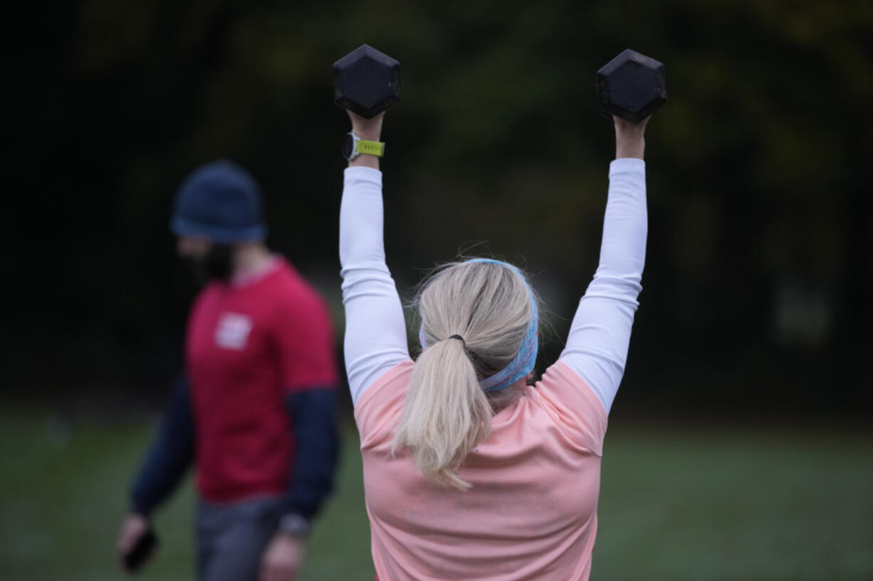 Personal fitness trainer Richard Lamb, leads a group in an outdoor gym class Oct. 26 in London.