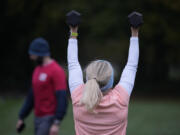 Personal fitness trainer Richard Lamb, leads a group in an outdoor gym class Oct. 26 in London.