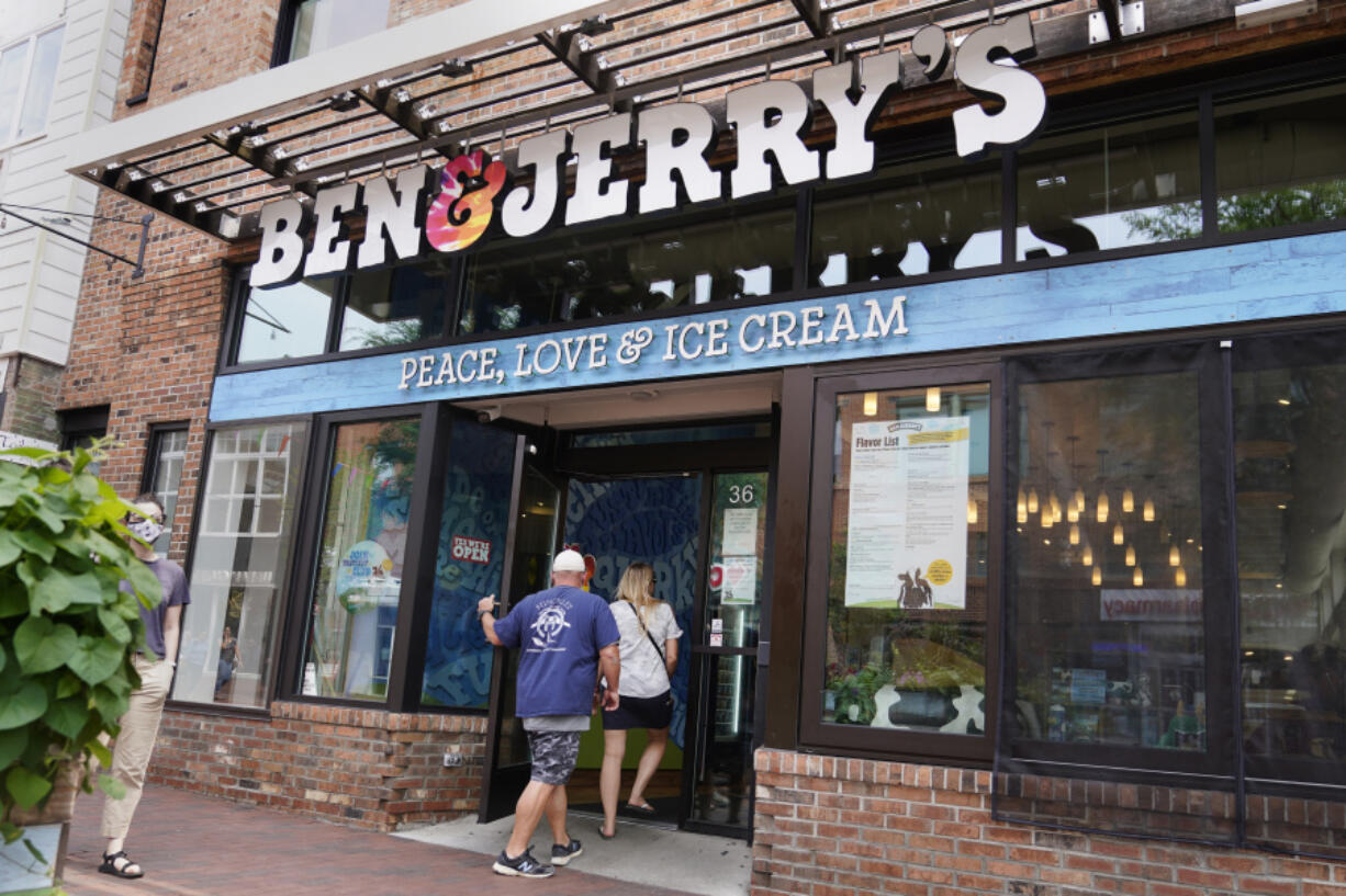 FILE - Two patrons enter the Ben &amp; Jerry&#039;s Ice Cream shop, July 20, 2021, in Burlington, Vt.