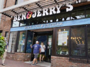 FILE - Two patrons enter the Ben &amp; Jerry&#039;s Ice Cream shop, July 20, 2021, in Burlington, Vt.