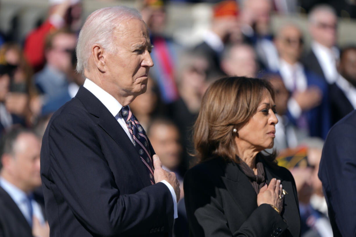 President Joe Biden, left, and Vice President Kamala Harris look on during a wreath-laying ceremony at the Tomb of the Unknown Soldier on National Veterans Day Observance at Arlington National Cemetery in Arlington, Va., on Monday.