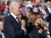 President Joe Biden, left, and Vice President Kamala Harris look on during a wreath-laying ceremony at the Tomb of the Unknown Soldier on National Veterans Day Observance at Arlington National Cemetery in Arlington, Va., on Monday.