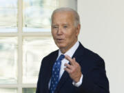 President Joe Biden, with his fingers crossed, speaks to reporters after being asked a question about a Gaza ceasefire, at the White House in Washington, Tuesday, Nov. 26, 2024.