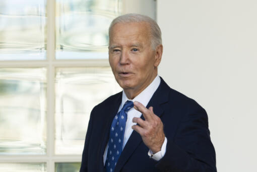 President Joe Biden, with his fingers crossed, speaks to reporters after being asked a question about a Gaza ceasefire, at the White House in Washington, Tuesday, Nov. 26, 2024.