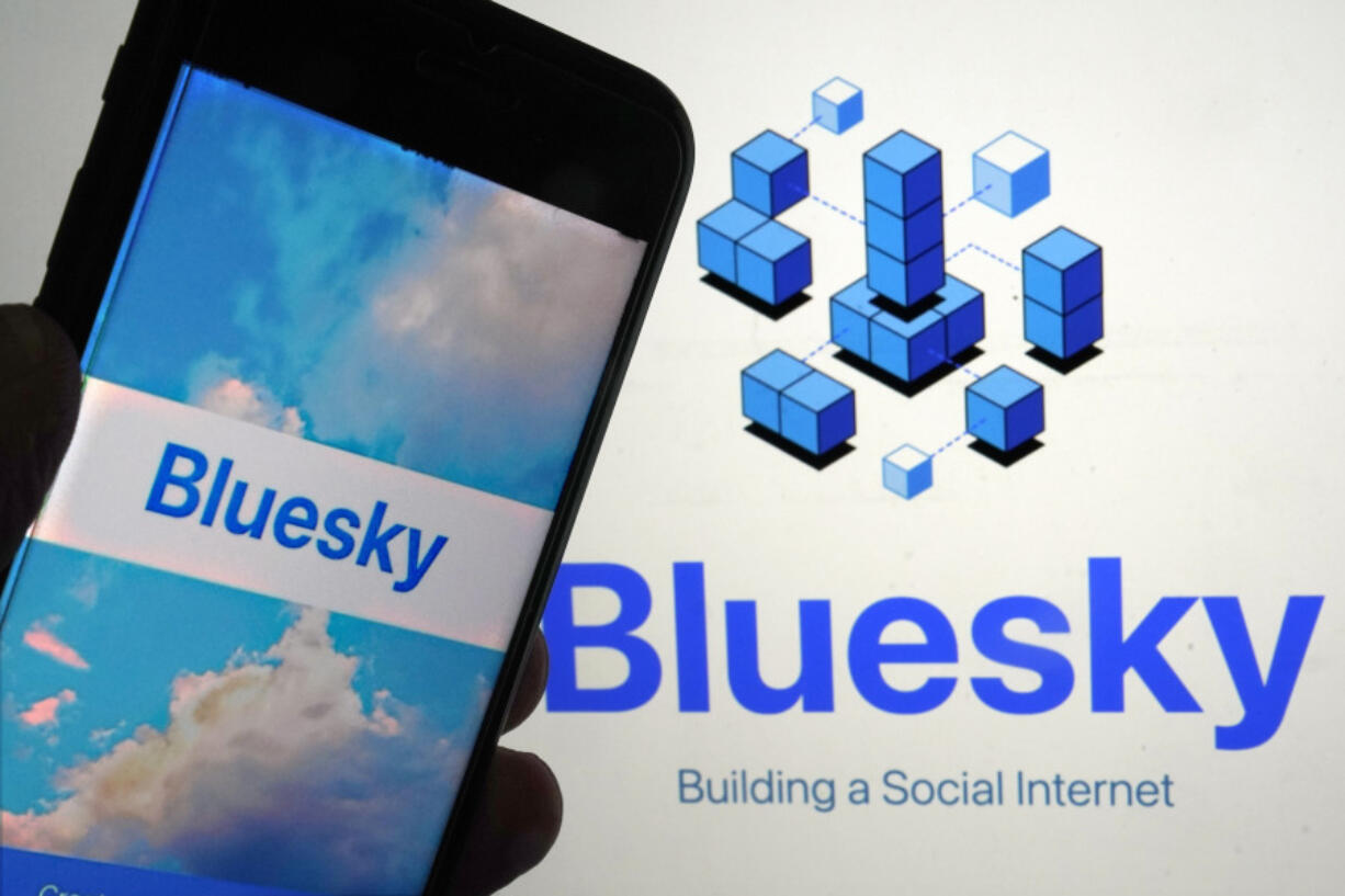 FILE - The app for Bluesky is shown on a mobile phone, left, and on a laptop screen on June 2, 2023, in New York.