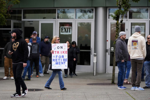 A worker holds a sign as Boeing employees vote on a new contract offer from the company, Wednesday, Oct. 23, 2024, at a voting location in the Angel of the Winds Arena in Everett, Wash.