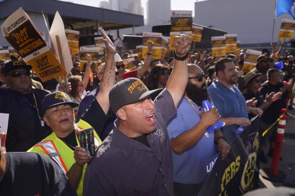 FILE - Teamsters and workers hold a rally in downtown Los Angeles, July 19, 2023, as a deadline neared in negotiations between the union and United Parcel Service.