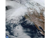 This satellite image taken, Nov. 19, 2024, and provided by NOAA, shows weather gathering in northern California and the Pacific Northwest.