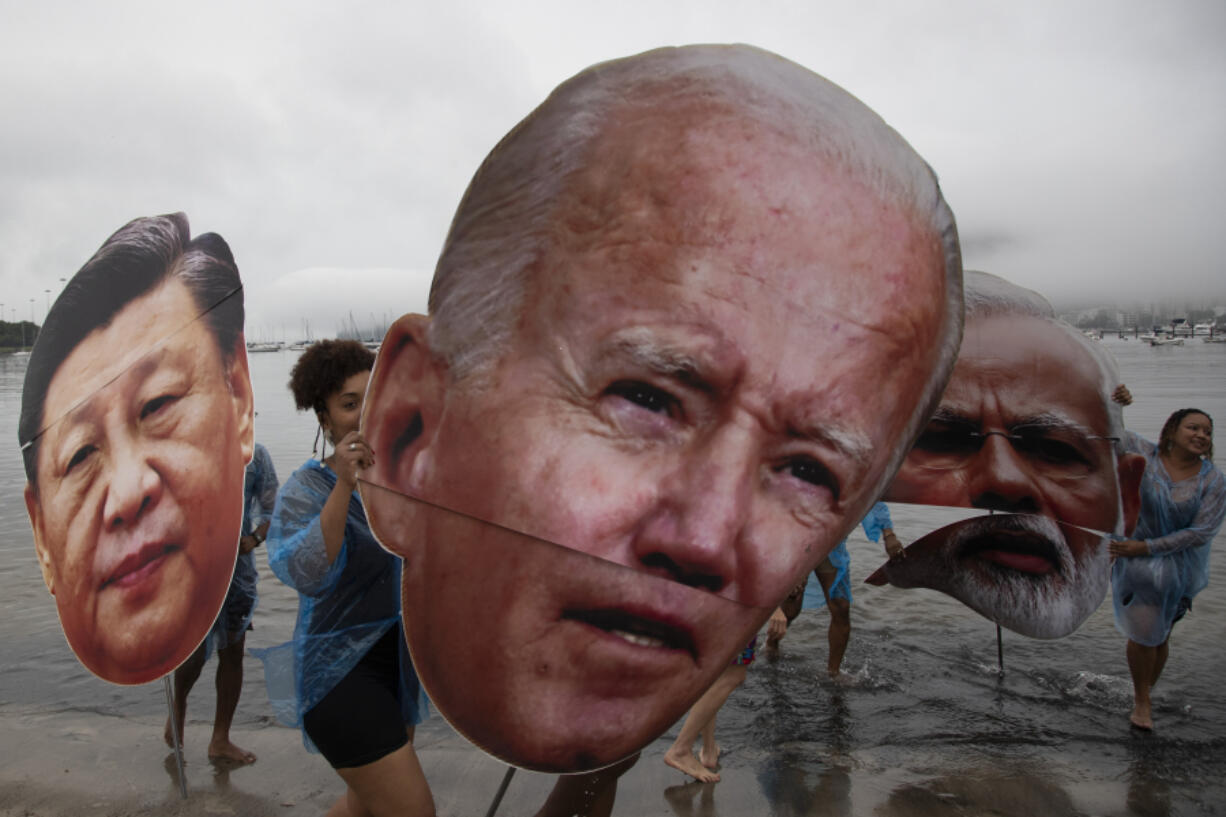 Activists from a Brazilian Indigenous movement hold cutouts of Chinese President Xi Jinping, from left, President Joe Biden and Indian Prime Minister Narendra Modi, during a protest aimed at drawing the attention on the global climate crisis to leaders attending the upcoming G20 Summit, at Botafogo Beach in Rio de Janeiro, Saturday, Nov. 16, 2024.