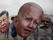 Activists from a Brazilian Indigenous movement hold cutouts of Chinese President Xi Jinping, from left, President Joe Biden and Indian Prime Minister Narendra Modi, during a protest aimed at drawing the attention on the global climate crisis to leaders attending the upcoming G20 Summit, at Botafogo Beach in Rio de Janeiro, Saturday, Nov. 16, 2024.