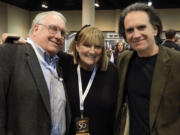 The children of Berkshire Hathaway Chairman and CEO Warren Buffett, from left, Howard Buffett, Susie Buffett, and Peter Buffett, pose for a photo at the CenturyLink Center exhibit hall in Omaha, Neb., May 1, 2015.