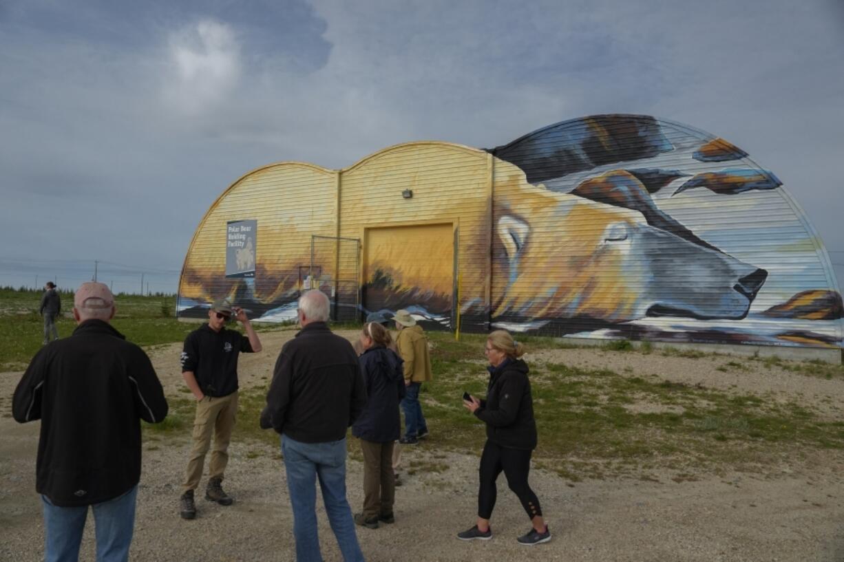 Tourists stand outside the Polar Bear Holding Facility, Sunday, Aug. 4, 2024, in Churchill, Manitoba. (AP Photo/Joshua A.