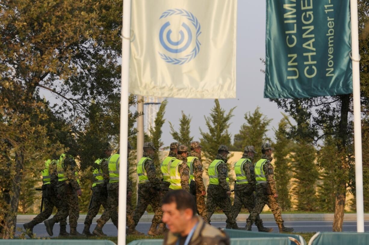 Security walk outside the venue for the COP29 U.N. Climate Summit, Tuesday, Nov. 19, 2024, in Baku, Azerbaijan.