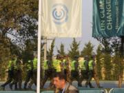 Security walk outside the venue for the COP29 U.N. Climate Summit, Tuesday, Nov. 19, 2024, in Baku, Azerbaijan.