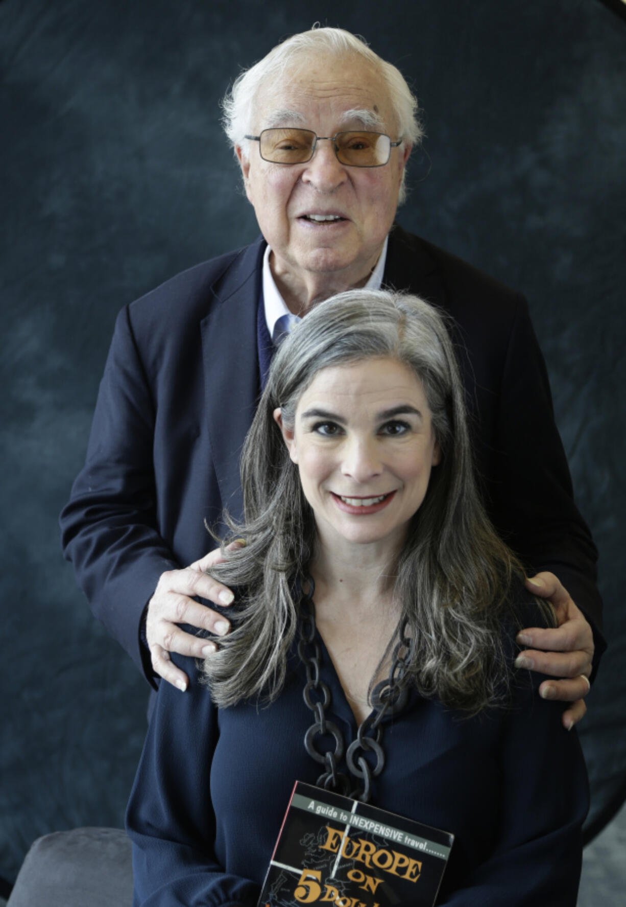 CORRECTS SPELLING OF LAST NAME - FILE - Arthur Frommer, background, poses with his daughter, Pauline, in New York, Jan. 6, 2017.