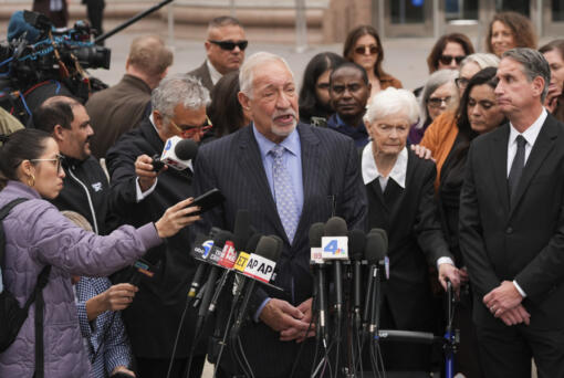 Joined by family members of Erik and Lyle Menendez, attorney Mark Geragos, center, speaks during a news conference after a hearing in Los Angeles, Monday, Nov. 25, 2024. (AP Photo/Jae C.