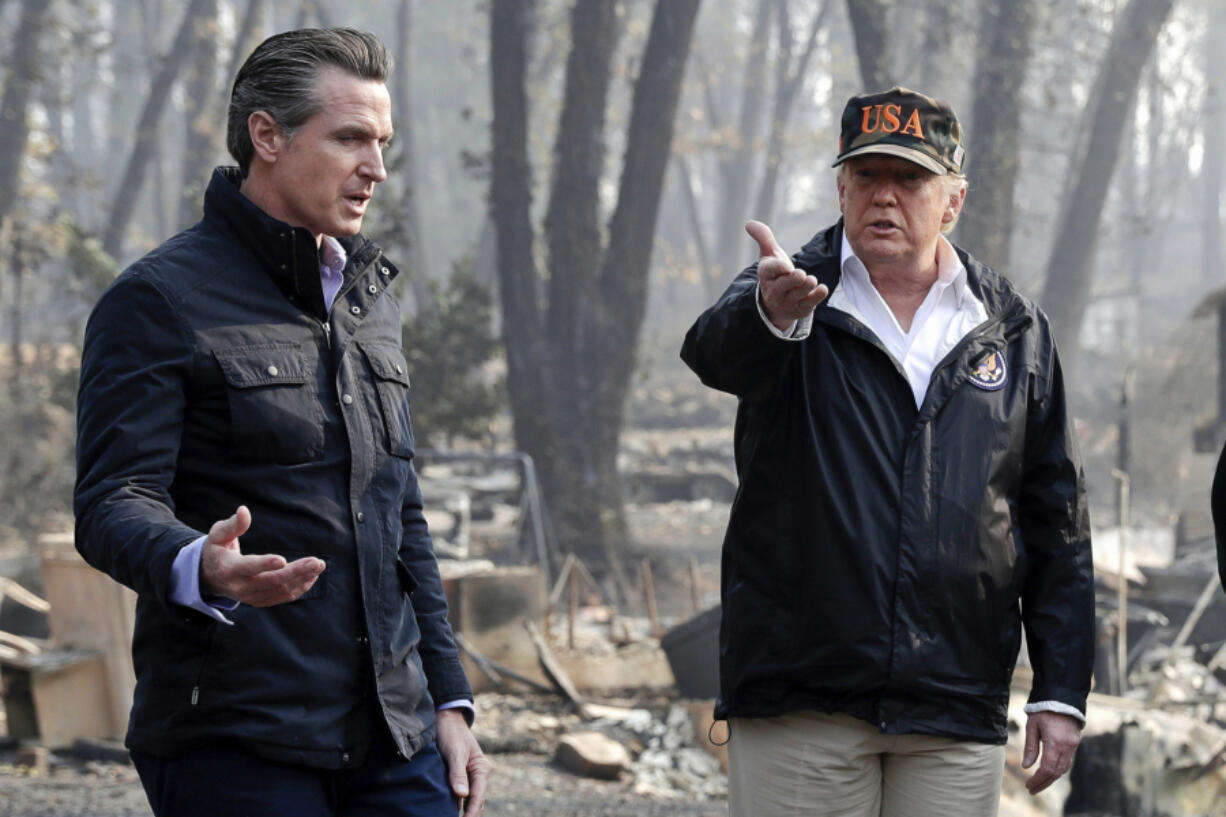 FILE - President Donald Trump talks with then California Gov.-elect Gavin Newsom, left, during a visit to a neighborhood impacted by the wildfires in Paradise, Calif., Nov. 17, 2018.