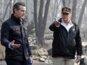 FILE - President Donald Trump talks with then California Gov.-elect Gavin Newsom, left, during a visit to a neighborhood impacted by the wildfires in Paradise, Calif., Nov. 17, 2018.