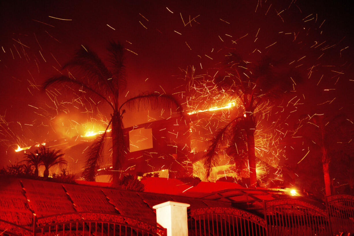 Flames consume a home as the Mountain Fire burns in Camarillo, Calif., on Wednesday, Nov. 6, 2024.