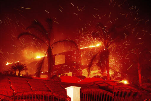 Flames consume a home as the Mountain Fire burns in Camarillo, Calif., on Wednesday, Nov. 6, 2024.