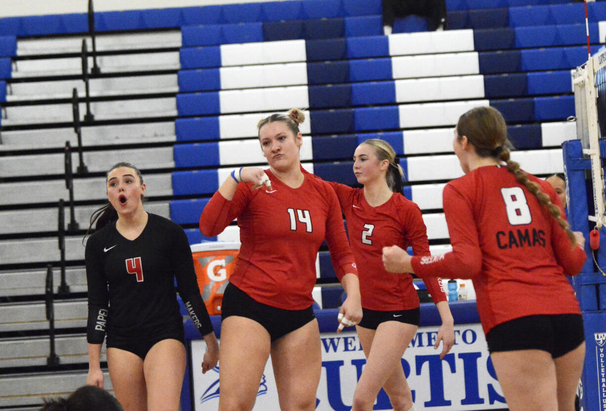 Shaylee Stephen (14) of Camas celebrates a block against Mount Rainier with teammates Emmah Sanchez (4), Ella Thompson (2) and Kendyl Wiest (8) in a Class 4A bi-district volleyball tournament match at Curtis High School in University Place on Friday, Nov. 15, 2024.