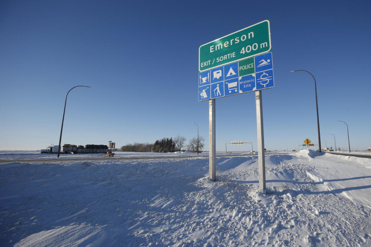 FILE - Road signage is posted just outside of Emerson, Manitoba on Thursday, Jan. 20, 2022.