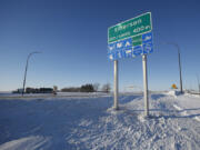 FILE - Road signage is posted just outside of Emerson, Manitoba on Thursday, Jan. 20, 2022.