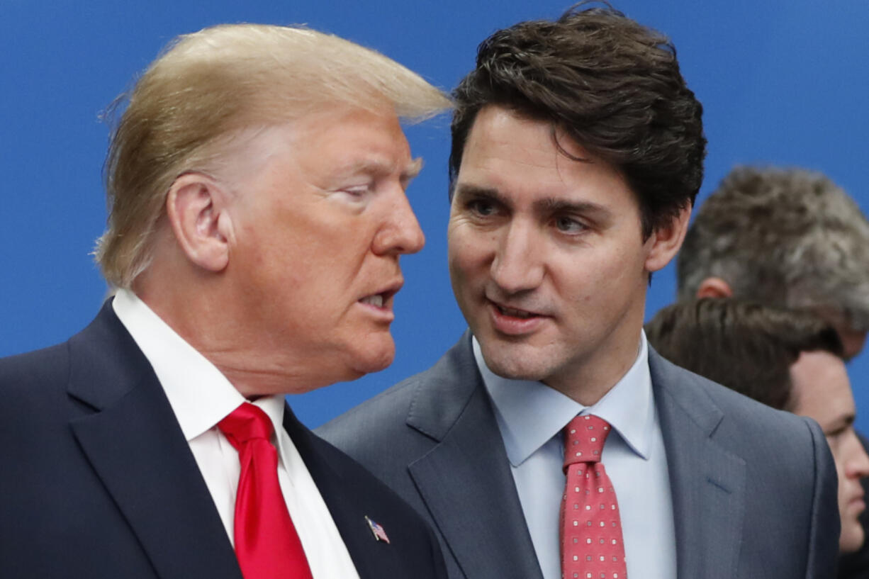 FILE - U.S. President Donald Trump, left, and Canadian Prime Minister Justin Trudeau talk prior to a NATO round table meeting at The Grove hotel and resort in Watford, Hertfordshire, England, Dec. 4, 2019.