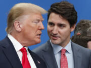 FILE - U.S. President Donald Trump, left, and Canadian Prime Minister Justin Trudeau talk prior to a NATO round table meeting at The Grove hotel and resort in Watford, Hertfordshire, England, Dec. 4, 2019.