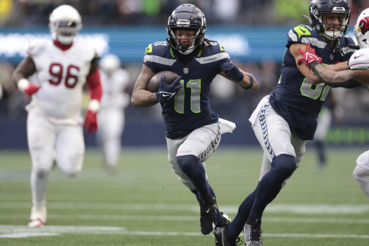 Seattle Seahawks wide receiver Jaxon Smith-Njigba (11) runs the ball for 46 yards, setting up a touchdown, during the first half of an NFL football game against the Arizona Cardinals, Sunday, Nov. 24, 2024, in Seattle.