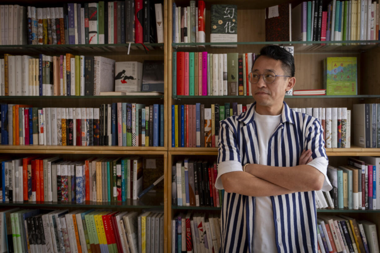 Yu Miao, owner of JF Books, poses for a photograph in his bookstore in Washington on Oct. 3.