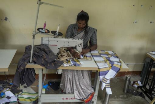 H. Gauri, 32, uses an electric sewing machine to stitch a cloth pouch in a small garage at the campus of the Swami Vivekananda Youth Movement, a nongovernmental organization that works to help poor and Indigenous communities, in Kenchanahalli, India, Monday, Sept. 23, 2024.