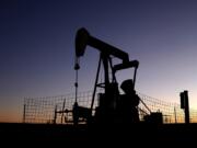 A pumpjack operates at dawn in a pasture, Monday, Sept. 30, 2024, near Hays, Kan.