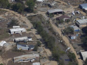 FILE - Damage from Hurricane Helene near Asheville, N.C., is seen during an aerial tour for President Joe Biden, Oct. 2, 2024.