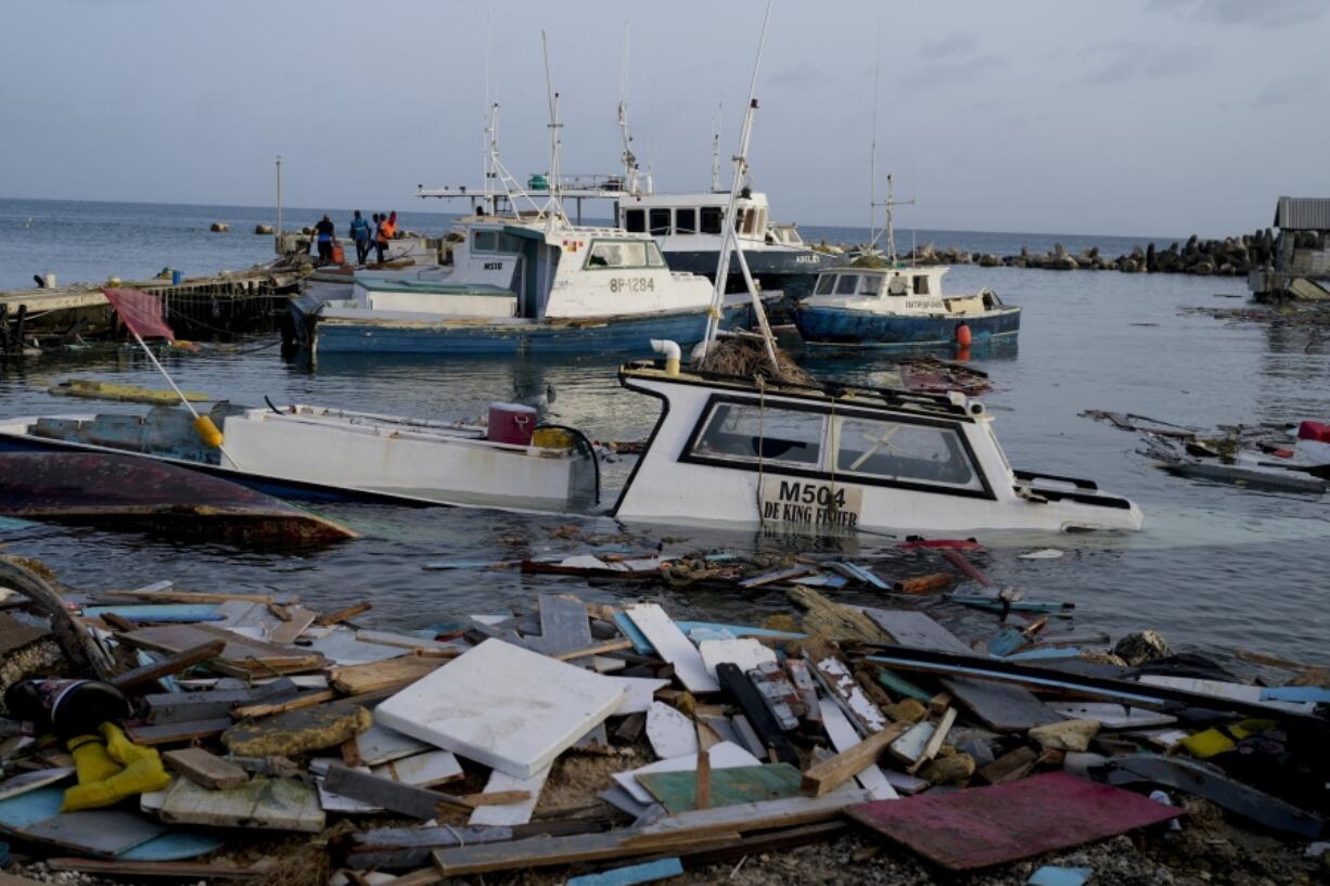 FILE - Boats damaged by Hurricane Beryl wade in the water at the Bridgetown Fisheries, Barbados, July 2, 2024.