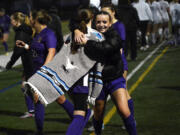 Ivy Henderson (right) of Columbia River hugs teammate Peyton Dukes after the Rapids' 4-0 win over Ellensburg in a Class 2A girls soccer state quarterfinal match at Columbia River High School on Saturday, Nov. 16, 2024.