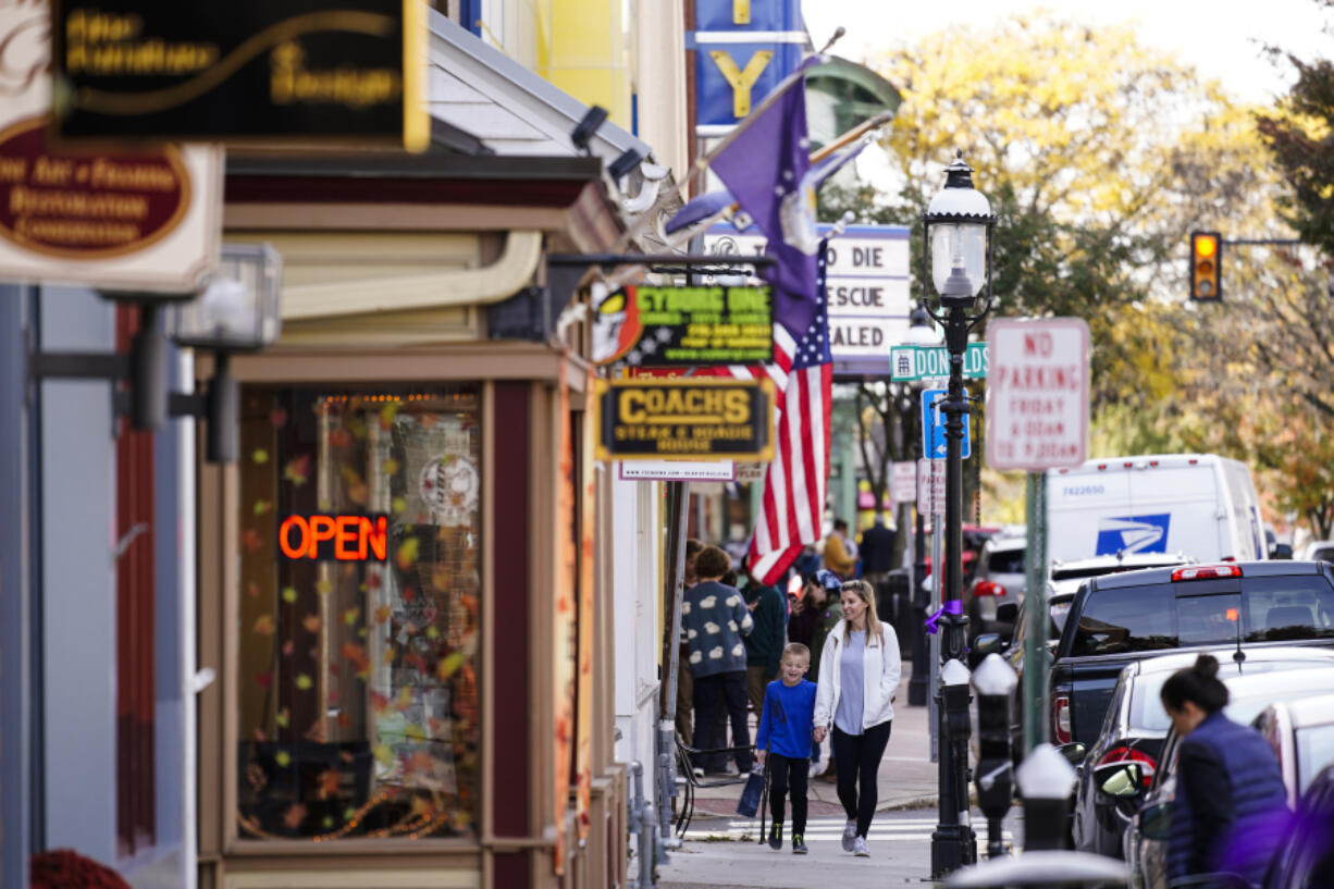 FILE - People walk past small businesses in Doylestown, Pa., Nov. 4, 2021.