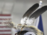 Eagle feathers adorn a headdress during a powwow in Montana, on April 6, 2024.