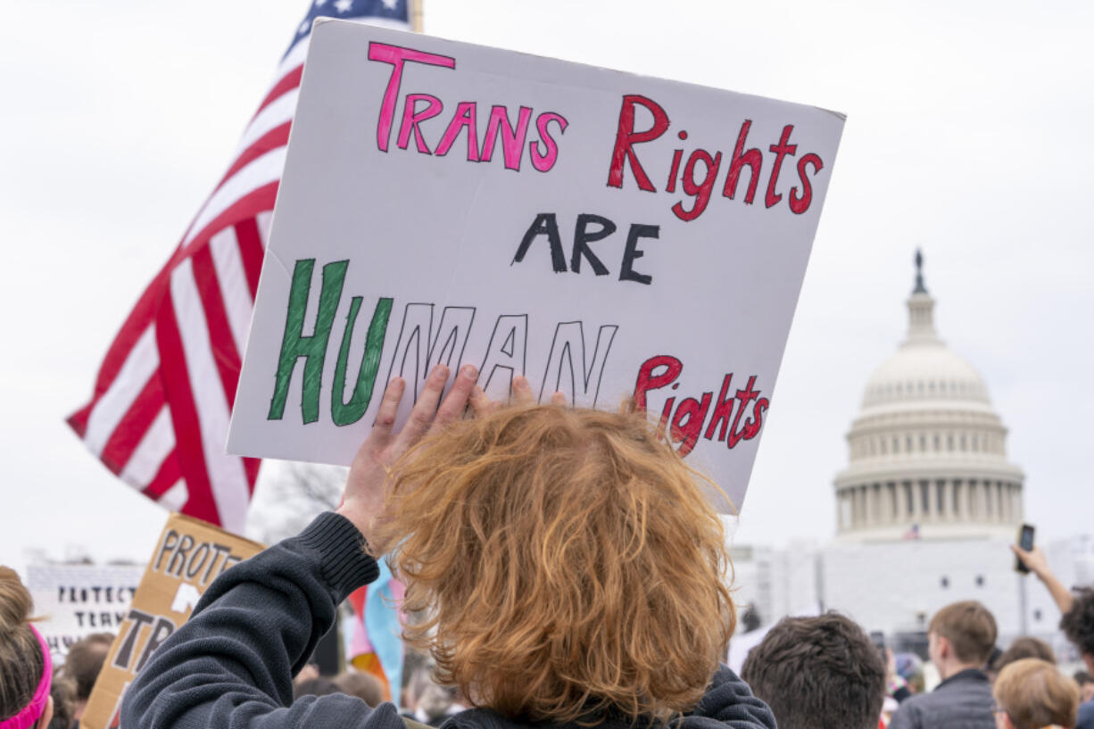 FILE - People attend a rally as part of a Transgender Day of Visibility, Friday, March 31, 2023, by the Capitol in Washington.