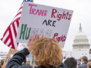 FILE - People attend a rally as part of a Transgender Day of Visibility, Friday, March 31, 2023, by the Capitol in Washington.