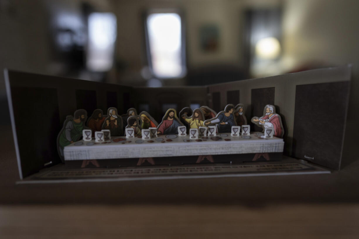 A paper cutout of The Last Supper, the last supper of Jesus with the Twelve Apostles, from the Gospel of John, is seen atop the piano in the Young&rsquo;s Sunbury, Ohio, home on Tuesday, Nov. 12, 2024.