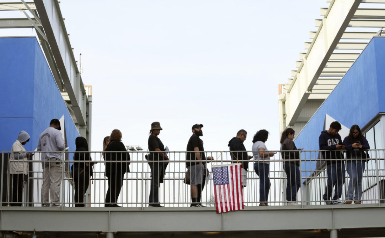 Voters wait in a long line at a polling place at the Michelle and Barack Obama Sports Complex on Election Day, Tuesday, Nov. 5, 2024, in Los Angeles.