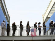 Voters wait in a long line at a polling place at the Michelle and Barack Obama Sports Complex on Election Day, Tuesday, Nov. 5, 2024, in Los Angeles.