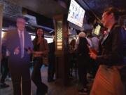 People takes pictures with a cutout of Republican presidential nominee former President Donald Trump at a watch party hosted by the New York Young Republican Club in New York on Election Day, Tuesday, Nov. 5, 2024.