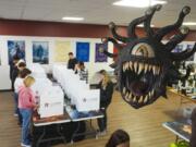 Beholder, a fictional monster in the Dungeons &amp; Dragons fantasy role-playing game, hangs over a voting site as voter cast their ballots on Election Day, at The Game Preserve store in Indianapolis, Tuesday, Nov. 5, 2024.