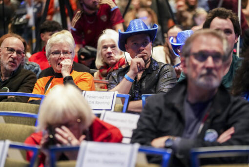 Attendees react to a news broadcast showing results at the Washington State Democrats watch party on Election Day, Tuesday, Nov. 5, 2024, in Seattle.