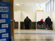 A child looks back while sitting in a voting booth at the King County Election headquarters on Election Day, Tuesday, Nov. 5, 2024, in Renton, Wash.