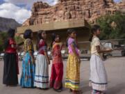 Young Havasupai dancers prepare to perform a traditional dance welcoming Democratic Senate candidate Ruben Gallego, in Supai, Ariz., Monday, Oct. 14, 2024. Gallego hoped to connect with voters in the Havasupai reservation, which has only 156 registered voters, to fulfill a campaign pledge to visit all the Native American tribes in Arizona.